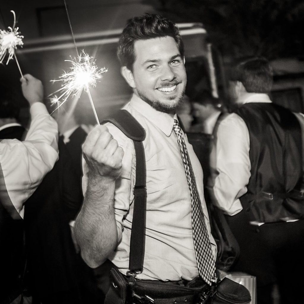 wedding photographer Matthew Foster holding sparkler