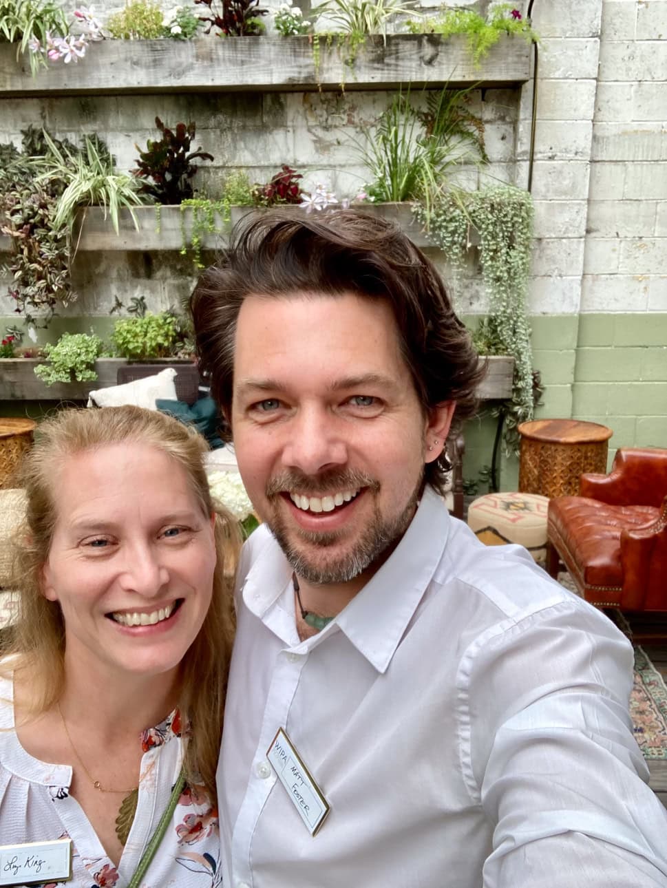 Photographers Matthew Foster and Liz King smiling at the camera at an event.
