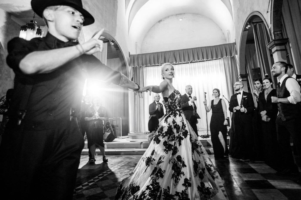Elegant bride in a floral gown enjoying her special moment on the dance floor.