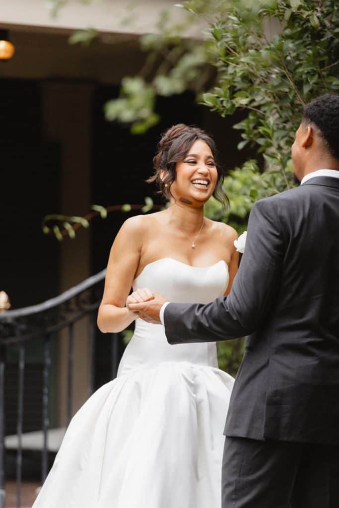 Elegant bride and groom sharing a dance outdoors, highlighting romantic moments at a New Orleans wedding.