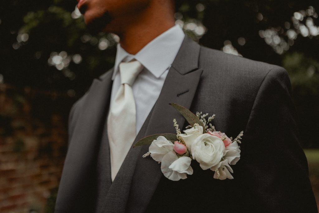 Close-up of a wedding boutonniere on a groom's suit jacket in New Orleans.
