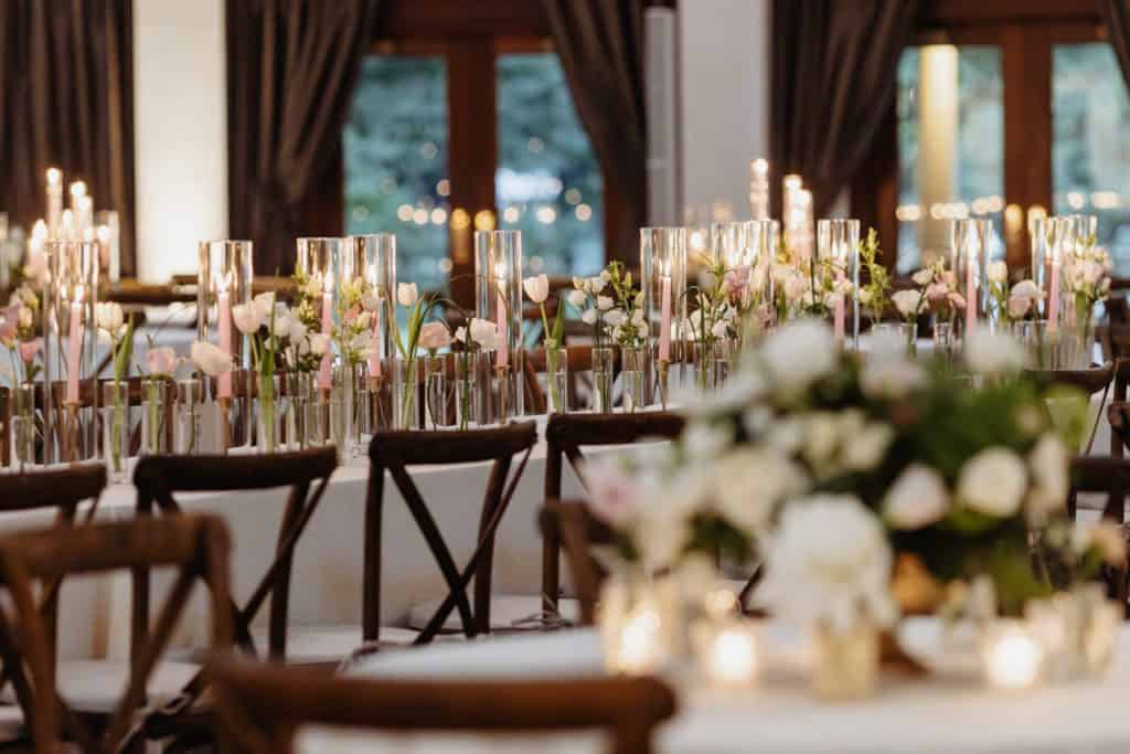 Beautifully decorated indoor wedding table with candles and floral arrangements in New Orleans.