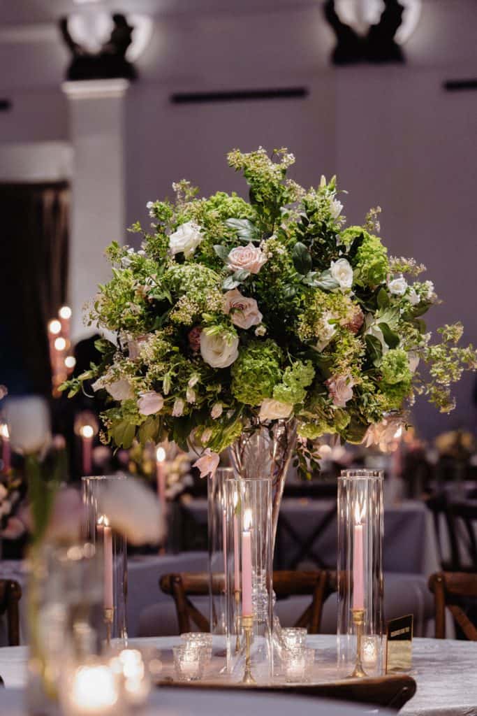 Stunning floral arrangement with roses and greenery at a wedding reception in New Orleans.