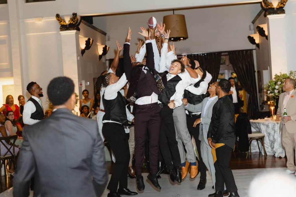 Diverse guests celebrating at a wedding reception in New Orleans with joyful dancing and lively atmosphere.