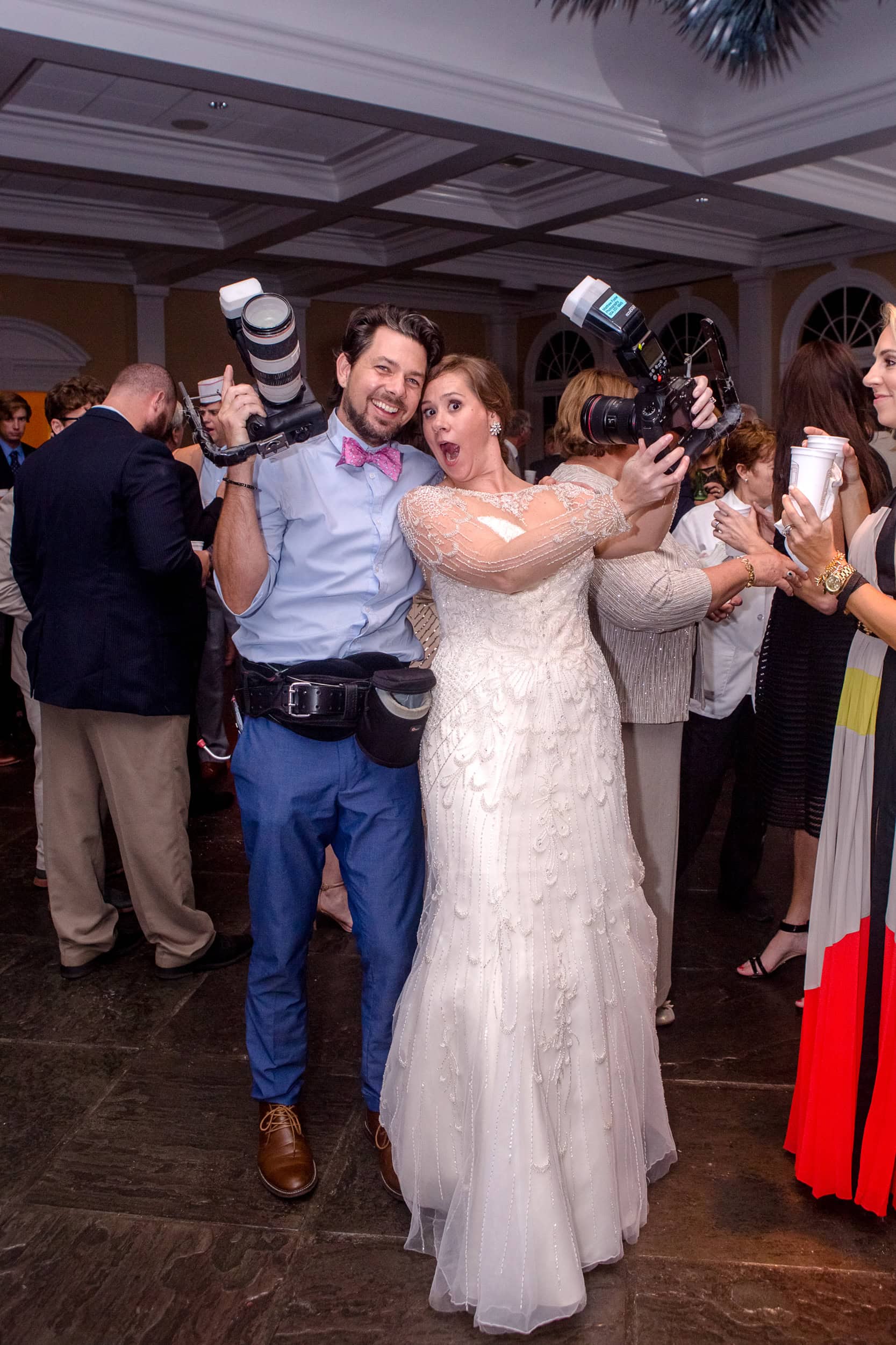 Wedding photographer Matthew Foster posing for photos with the bride at a New Orleans wedding reception.