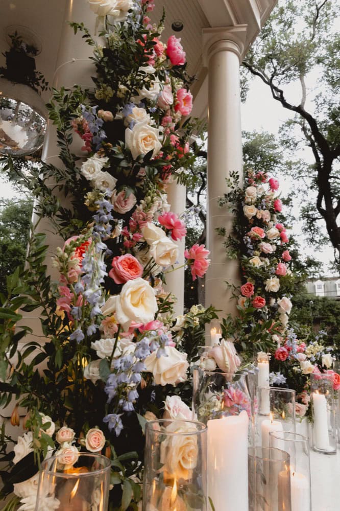 Beautiful floral arrangements featuring roses and lush greenery for a wedding setting.