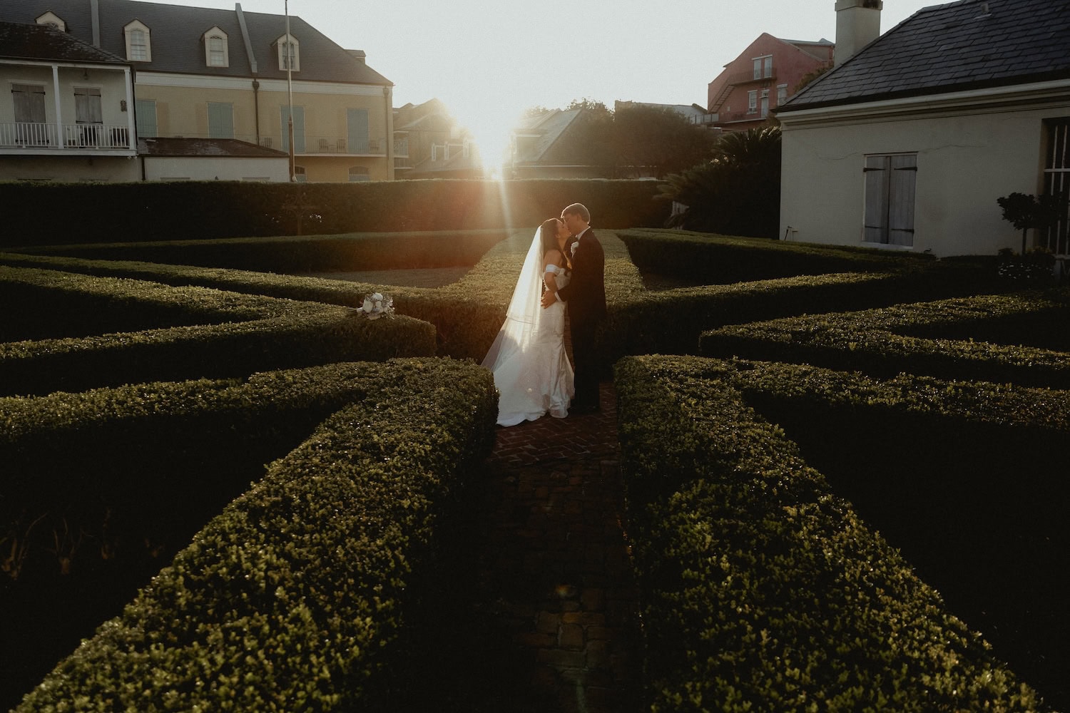 Wedding couple in the garden at the Old Ursuline Convent at sunset, New Orleans.