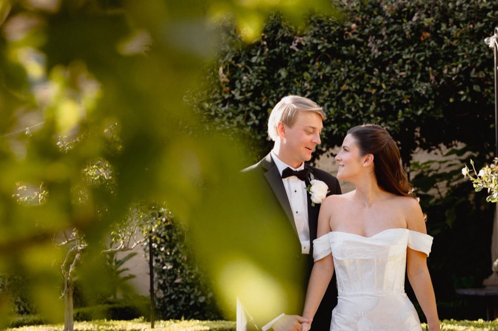 Wedding couple smiling outdoors in New Orleans at the BK House and Garden.