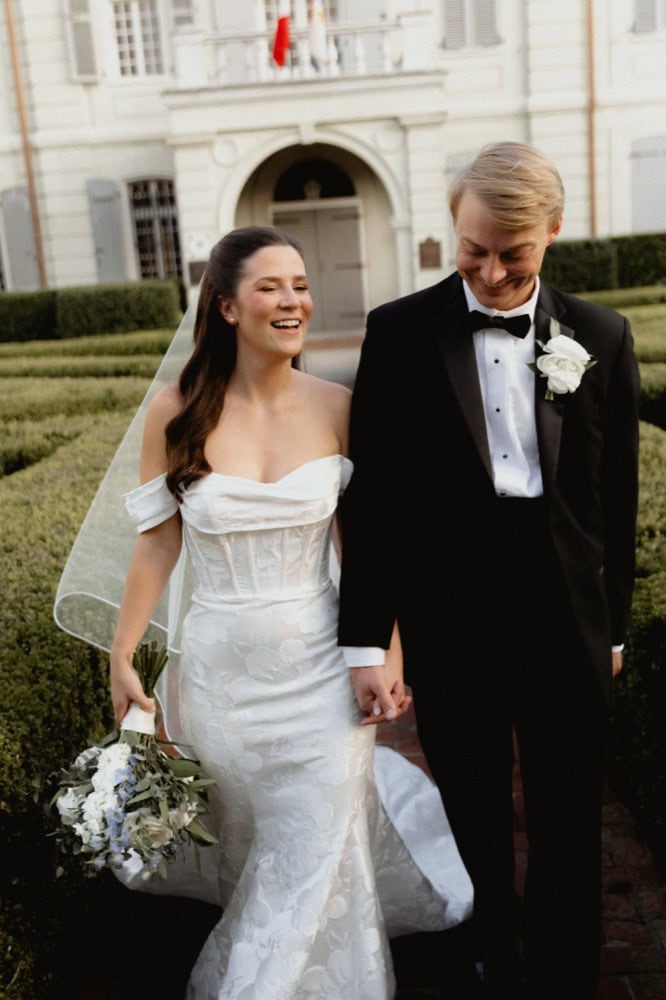Happy bride and groom walking outside the Old Ursuline Convent in New Orleans.