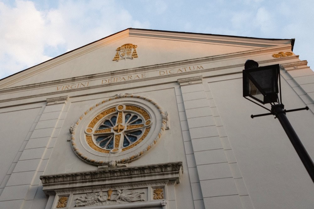 Historic New Orleans church. the Old Ursuline Convent facade with ornate details and a large circular window.