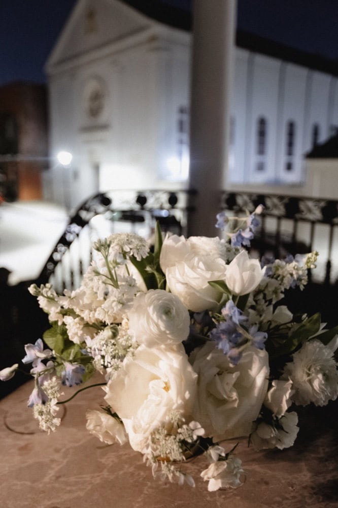 Wedding bouquet featuring white roses and delicate lavender accents.