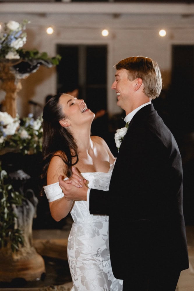 Joyful couple dancing at their wedding reception in New Orleans, capturing love and happiness.
