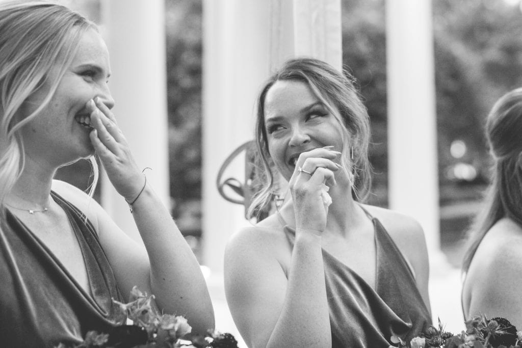 Two bridesmaids react with glee at a wedding ceremony in New Orleans.