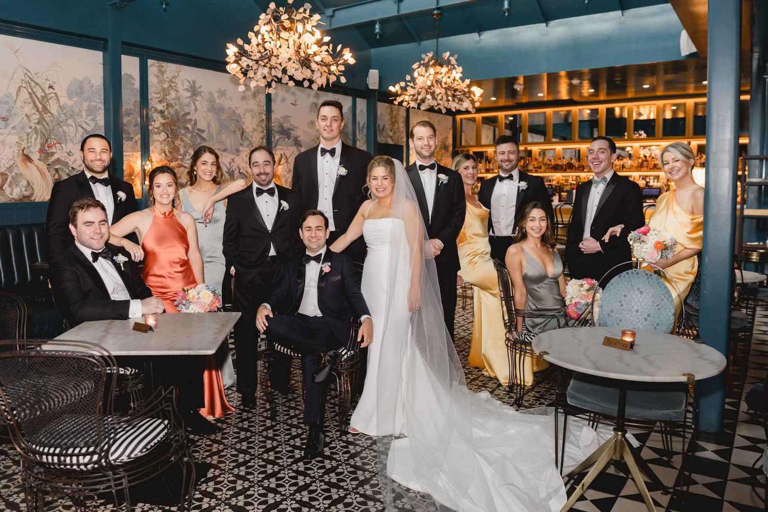 Elegant wedding party with bride and groom in a modern, chic setting.