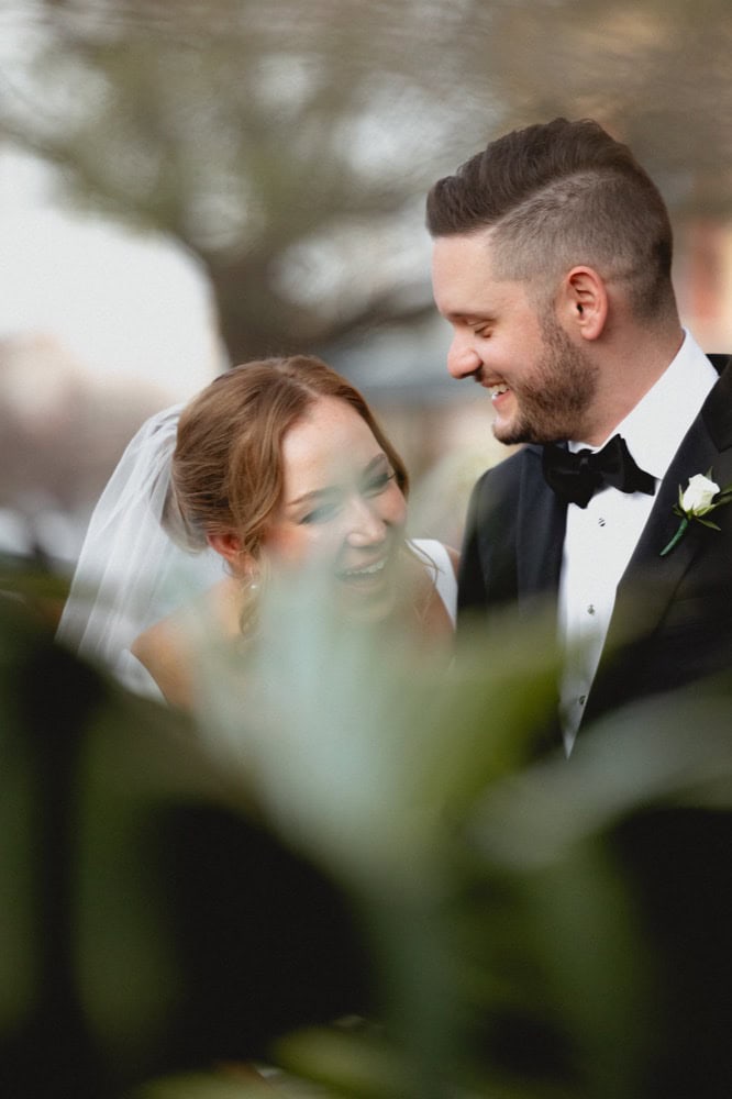 Elegant wedding couple smiling outdoors in New Orleans, capturing love and joy.