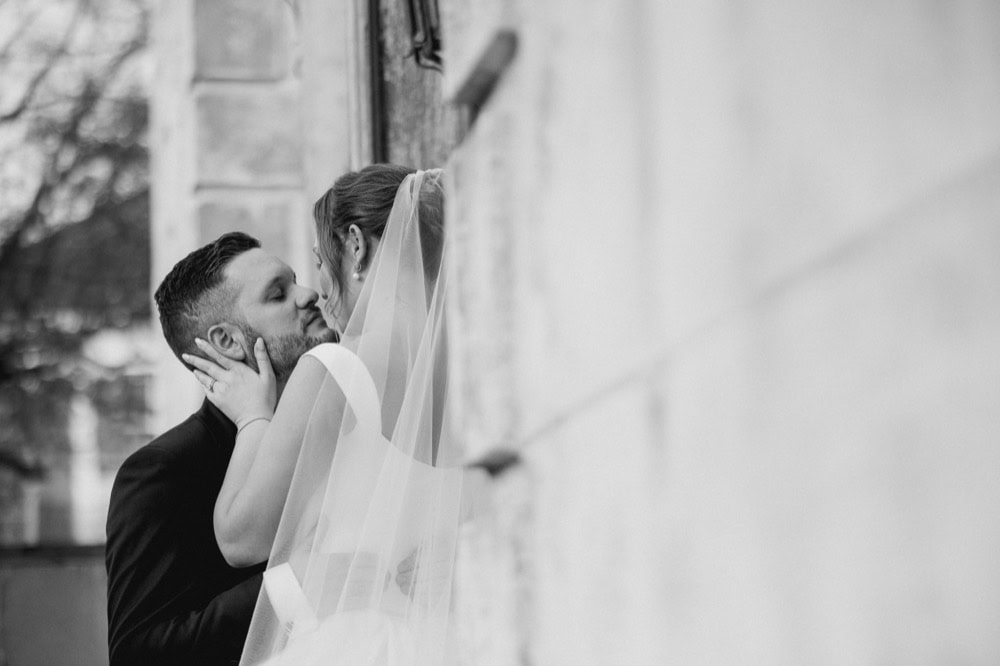 Wedding couple sharing a kiss in New Orleans, black and white photo.