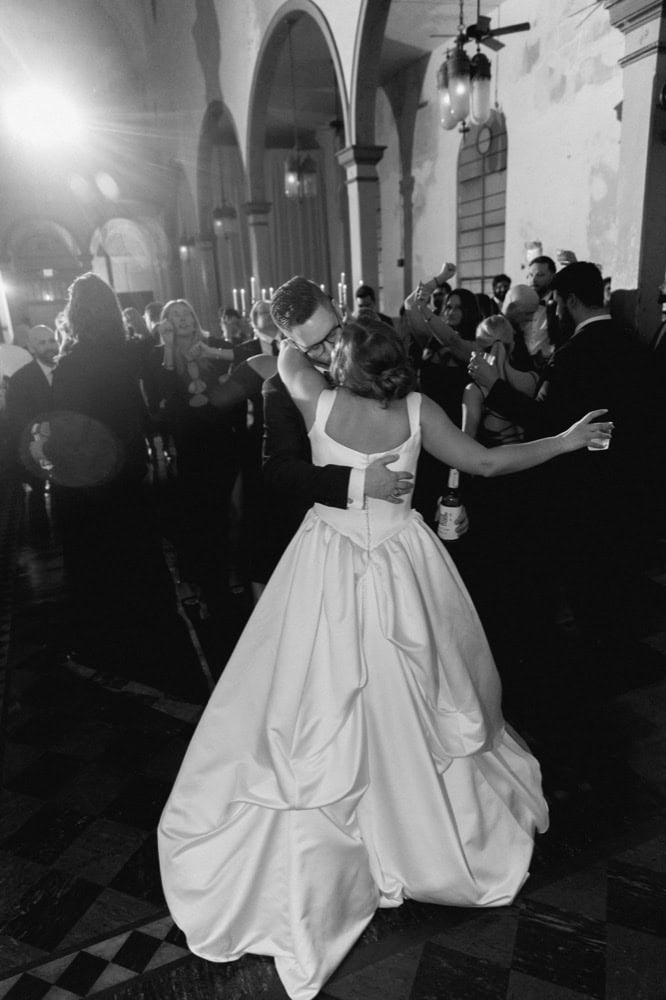 Couple sharing a romantic dance during their wedding reception in a historic New Orleans building.