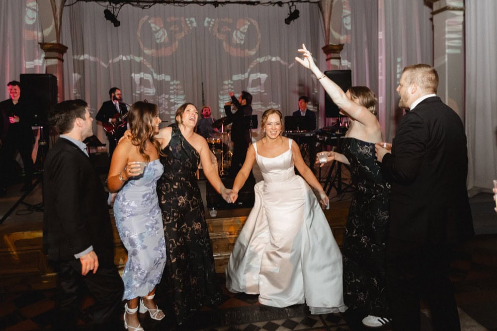 Dancing wedding guests celebrate at a New Orleans wedding reception with live music and joyful atmosphere.
