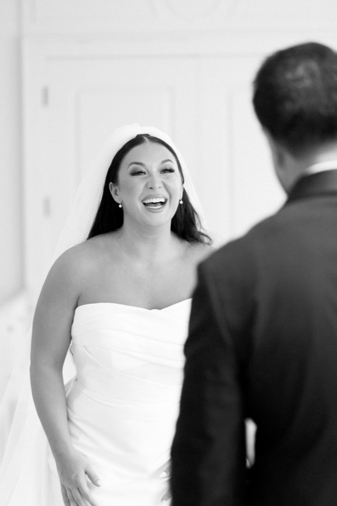 A bride smiles at her groom during their first look at the Virgin Hotel in New Orleans.