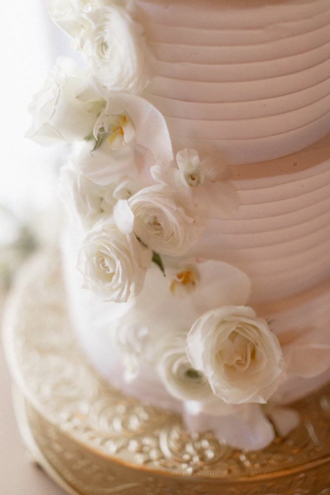 White wedding cake with white florals.