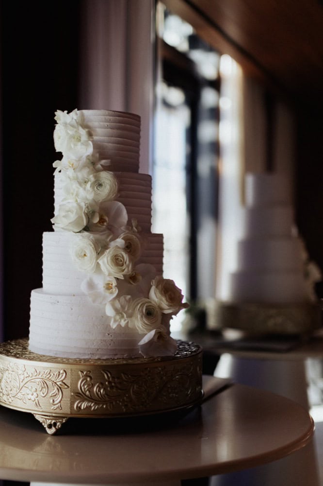White wedding cake with white florals.