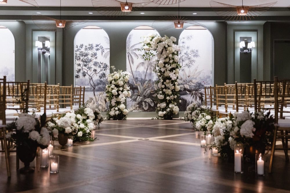 White floral archway creating an altar for a wedding at the Virgin Hotel in New Orleans.