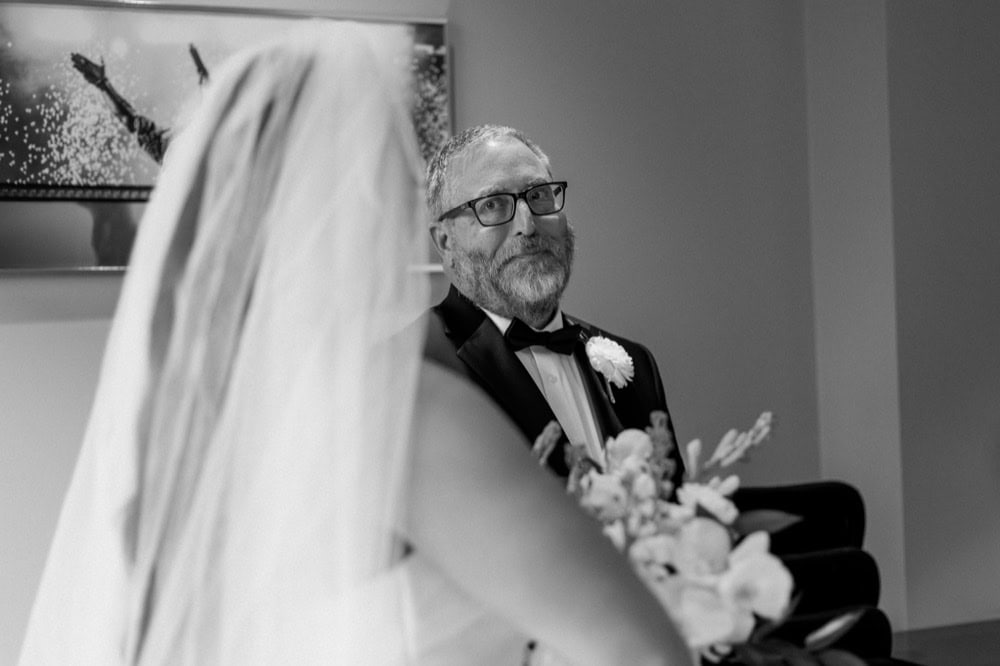 Bride's father looks at her lovingly before her wedding in New Orleans.