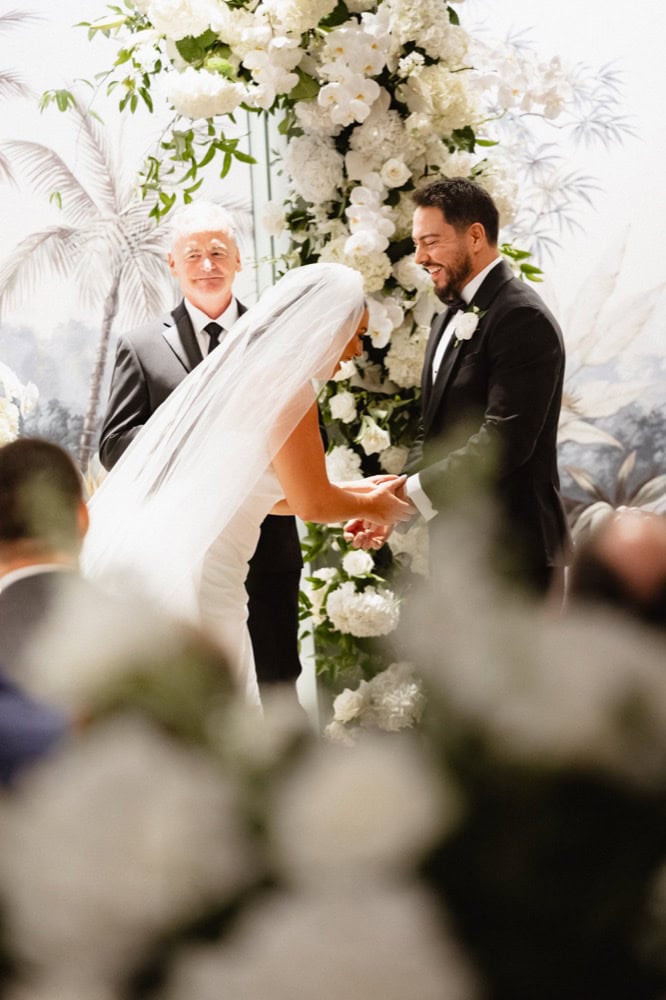 Bride and groom laugh together at their wedding at the Virgin Hotel in New Orleans.