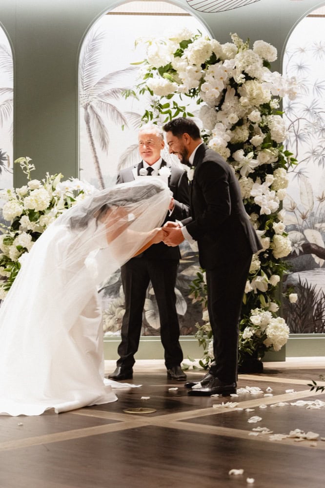 Bride and groom laugh together at their wedding at the Virgin Hotel in New Orleans.