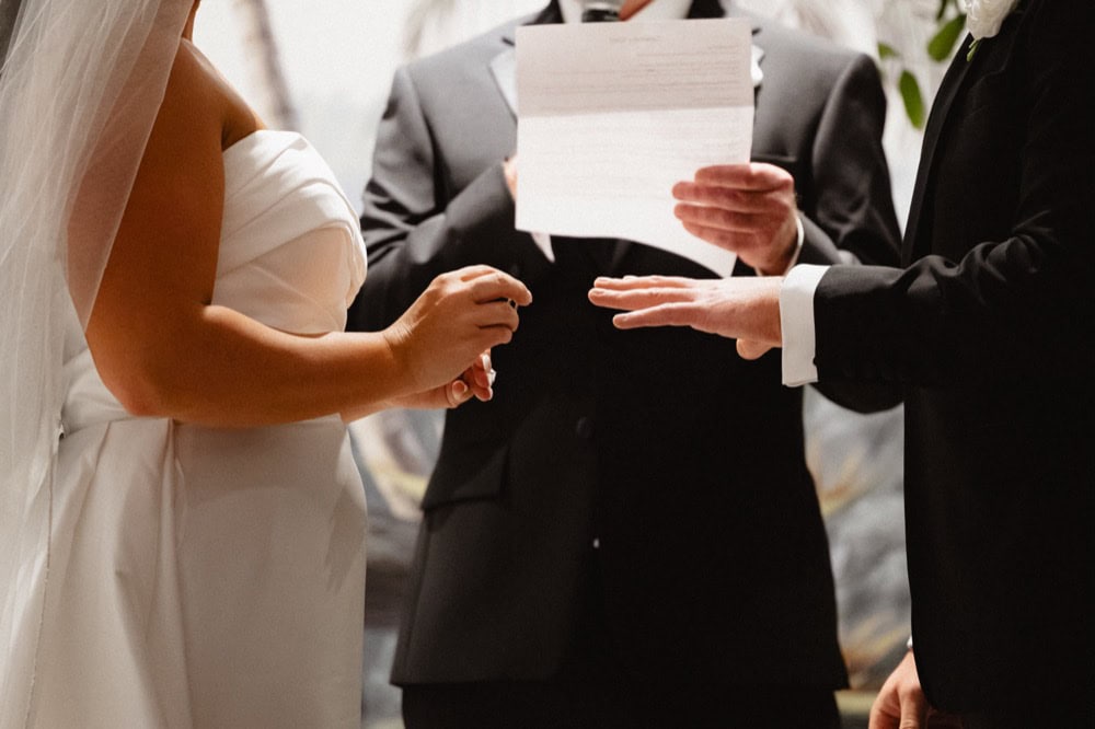 Bride and groom exchange rings at their wedding at the Virgin Hotel in New Orleans.