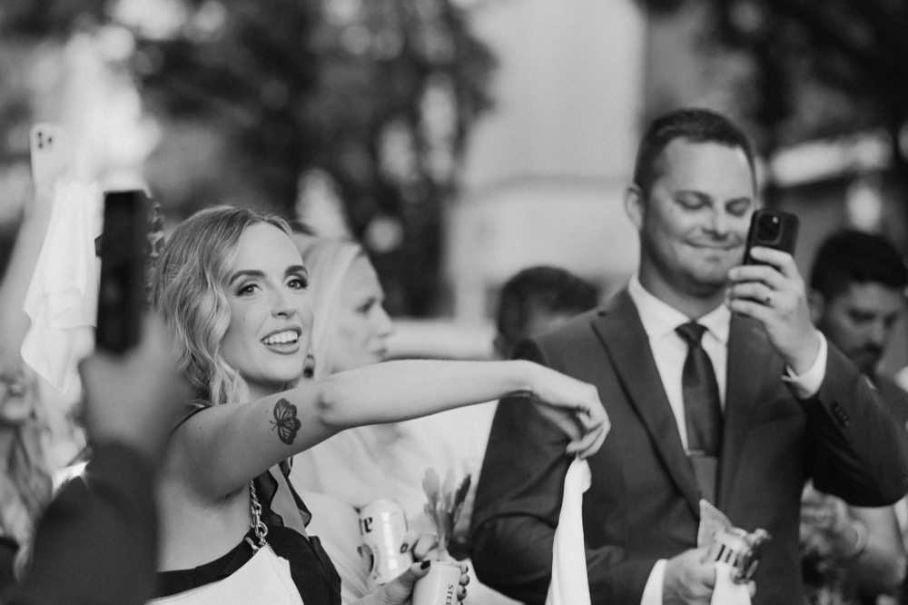 Wedding guests celebrating in New Orleans during a second line parade.