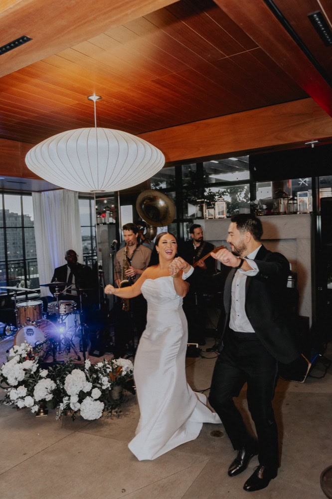 A bride and groom celebrate at their wedding reception at the Virgin Hotel in New Orleans.