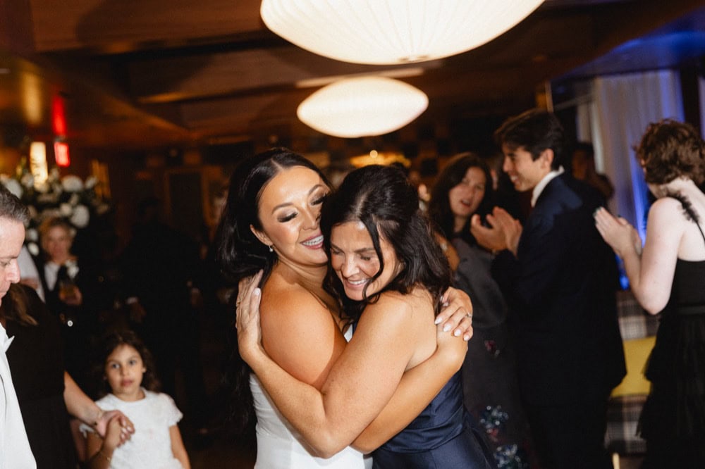 The bride and her mother embrace at a wedding reception at the Virgin Hotel in New Orleans.