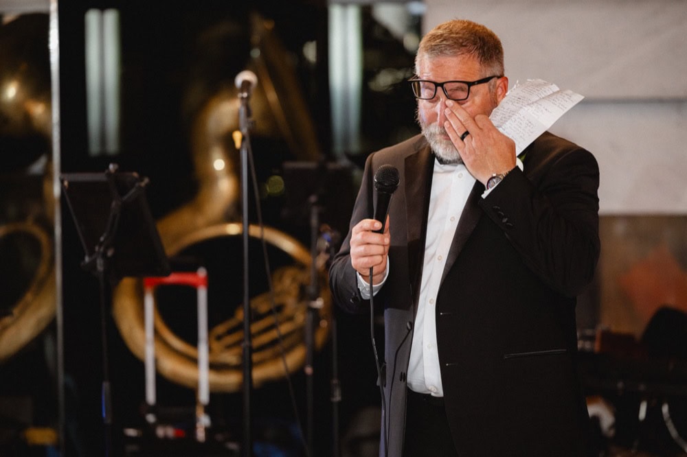 The father-of-the-bride wipes a tear away as he gives his wedding toast at his daughter's wedding in New Orleans.