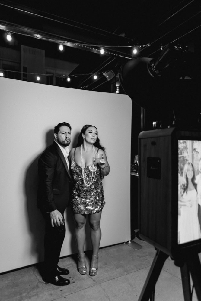 The bride and groom get their photo taken at a photo booth at their wedding in New Orleans.