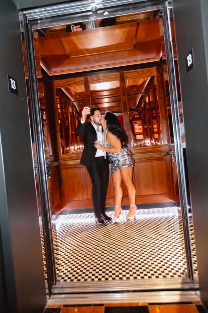 The bride and groom share a kiss in the elevator of the Virgin Hotel in New Orleans at the end of their wedding.