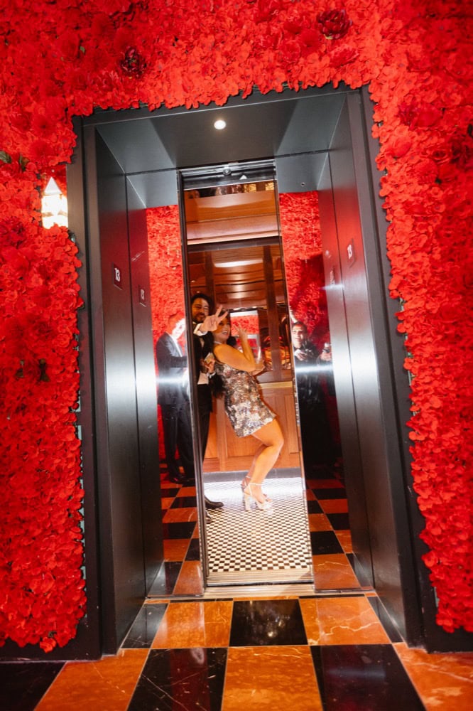 The bride and groom celebrate in the elevator of the Virgin Hotel in New Orleans at the end of their wedding.