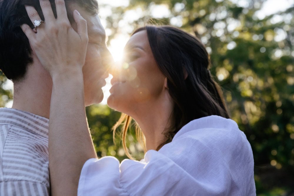 Couple kissing outdoors during sunset, wedding photography by Matthew Foster.