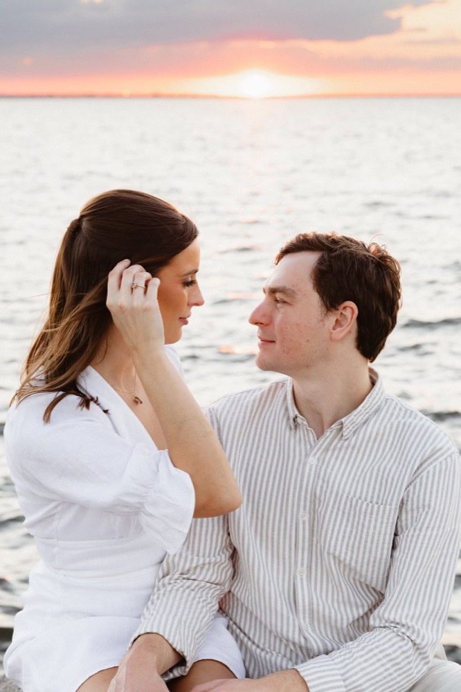 Romantic couple by the water at sunset, New Orleans wedding photography.