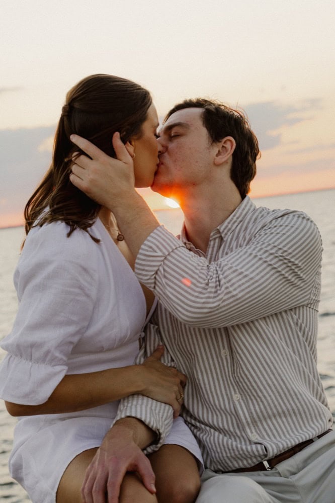 Romantic couple kissing at sunset at the lakefront in New Orleans.