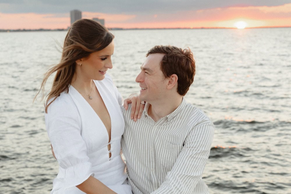 Romantic couple by the water at sunset in New Orleans.