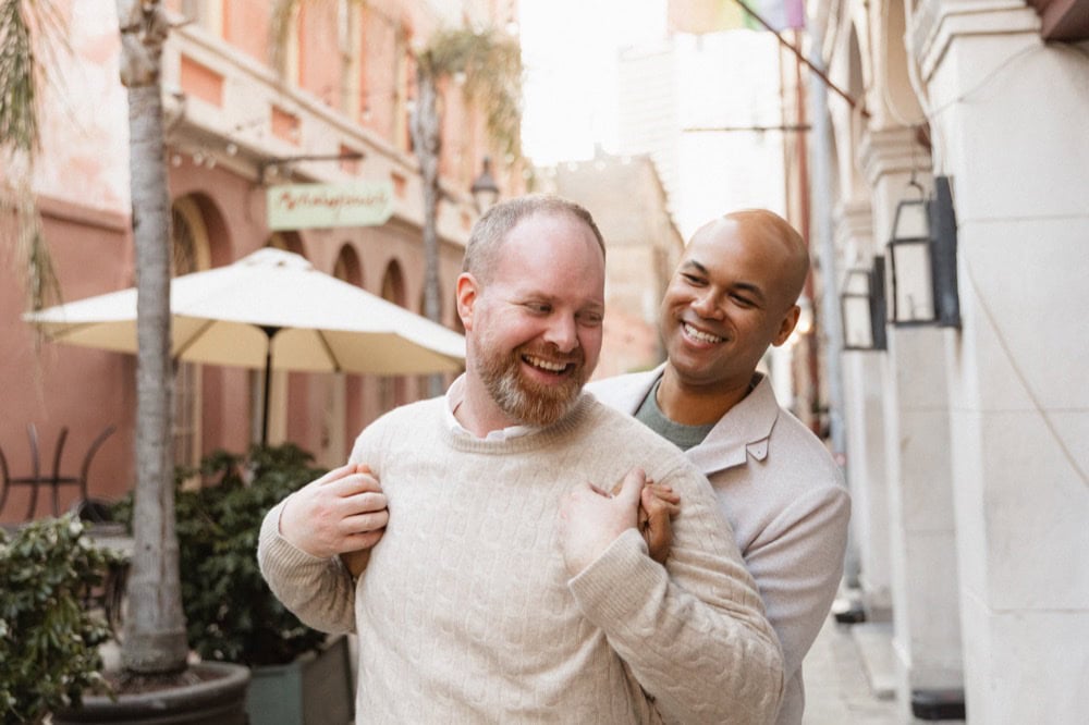 Happy couple in New Orleans street, wedding photography by Matthew Foster.