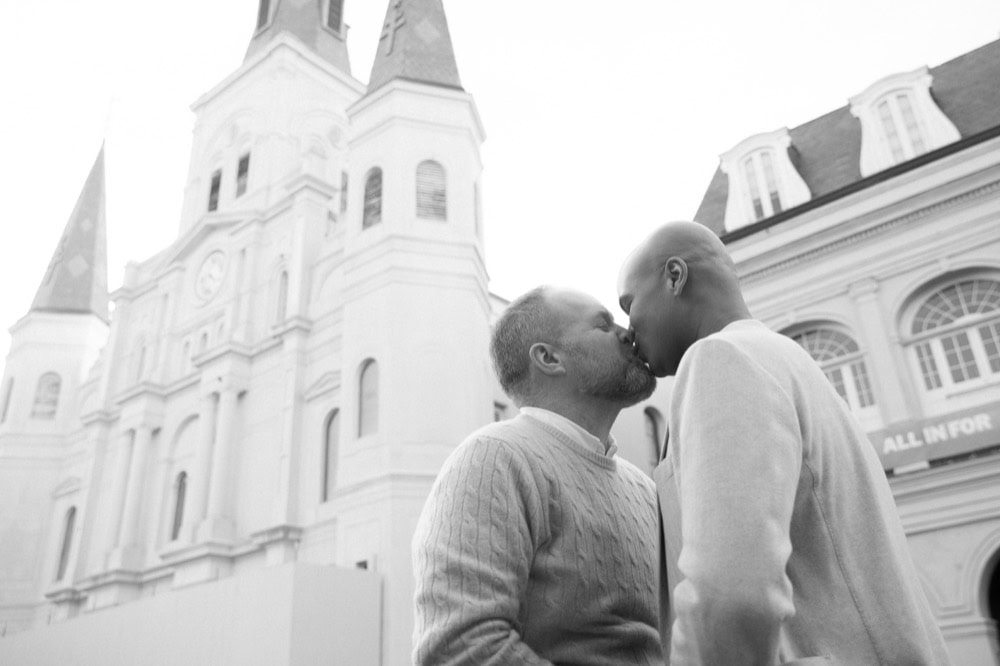 Couple kissing in front of historic St. Louis Cathedral in New Orleans.