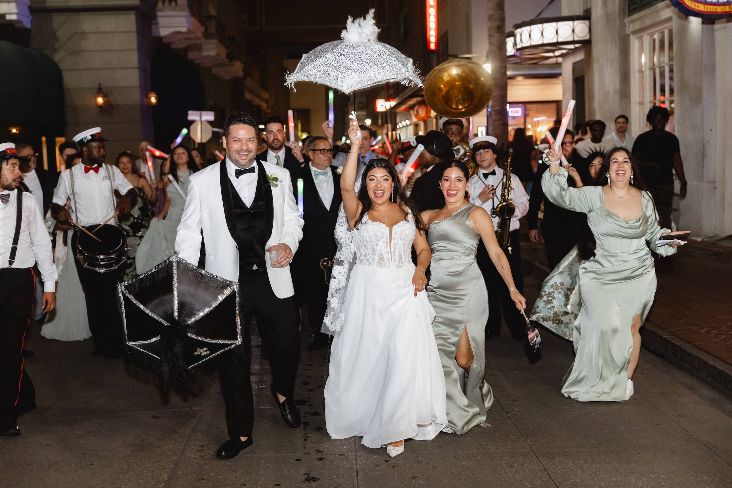 Wedding celebration in New Orleans with joyful couple and lively crowd.