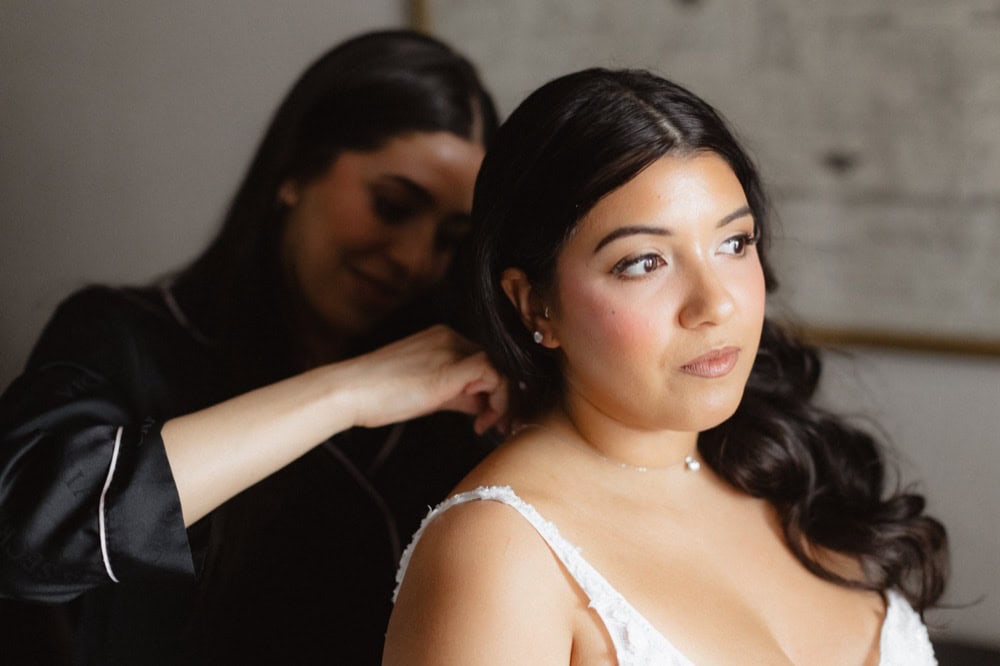 Wedding hair stylist helping bride get ready in New Orleans.