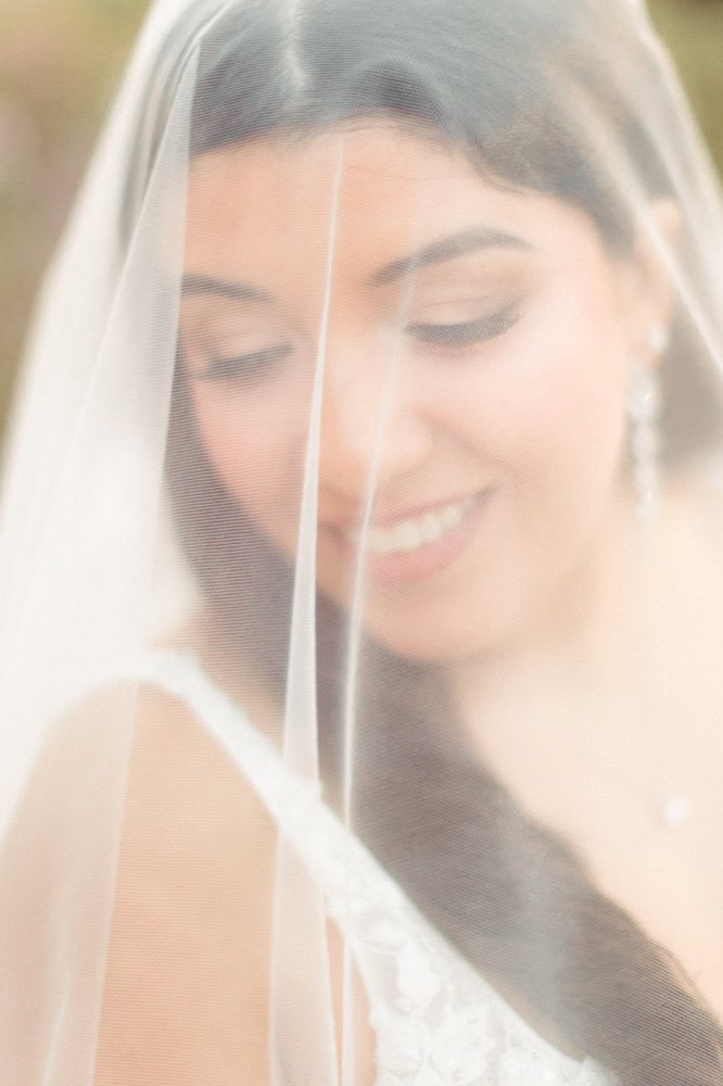 Beautiful bride with veil and soft makeup, captured by New Orleans wedding photographer Matthew Fost.