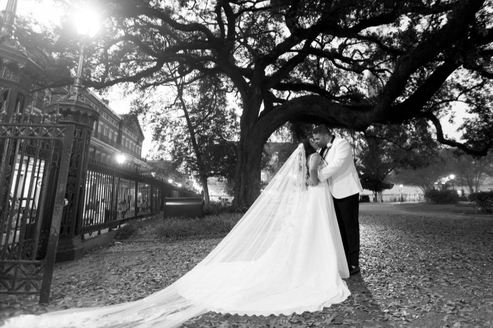 Bride and groom sharing a romantic moment outdoors in New Orleans.
