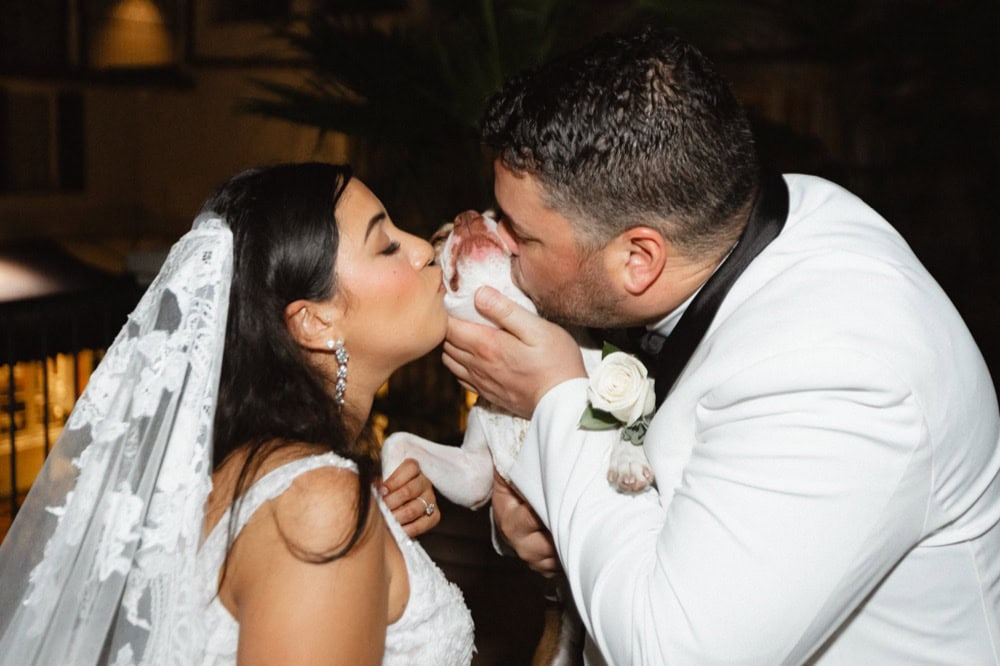 Wedding kiss between bride and groom at New Orleans wedding reception.