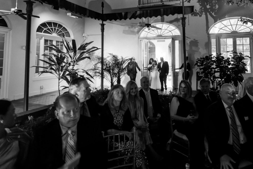 Guests seated indoors at a wedding reception in New Orleans, enjoying a formal celebration.