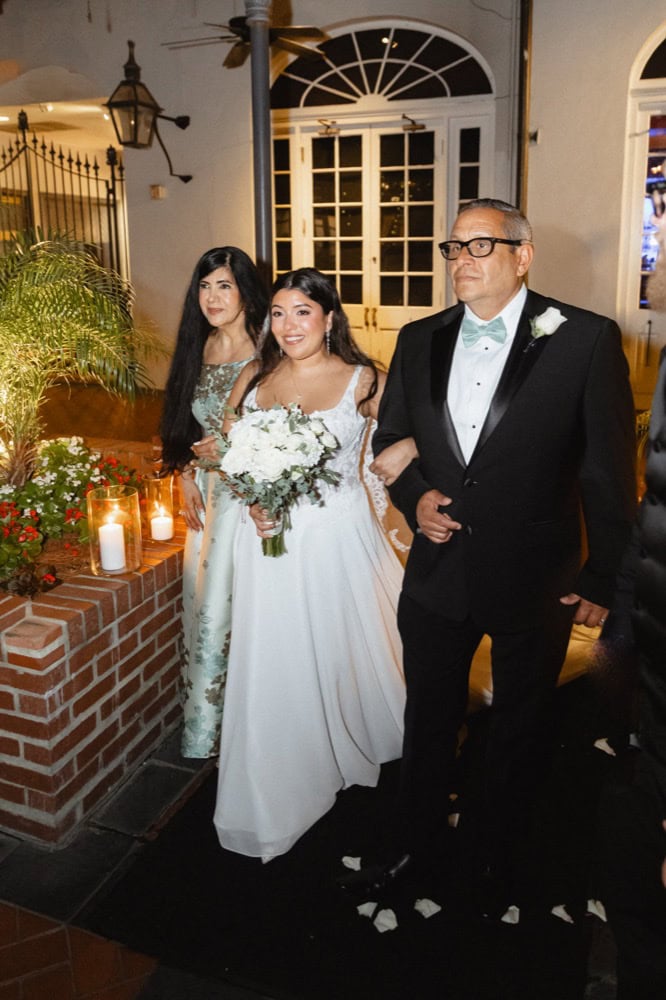 Bride walking with her father at her wedding in New Orleans.